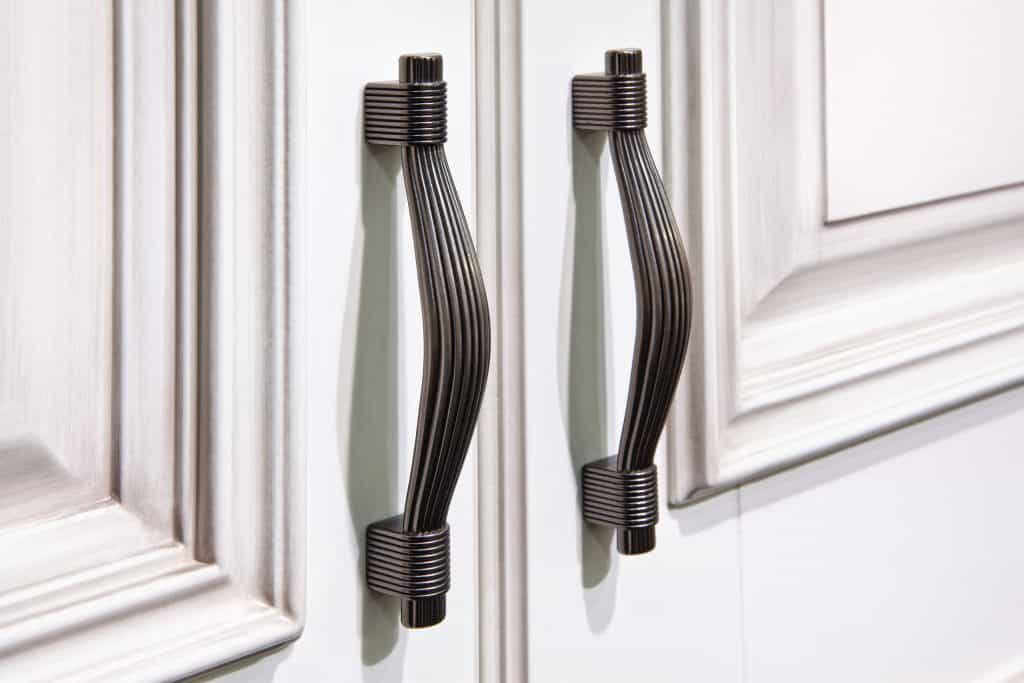 silver handles with snaps on cabinet doors