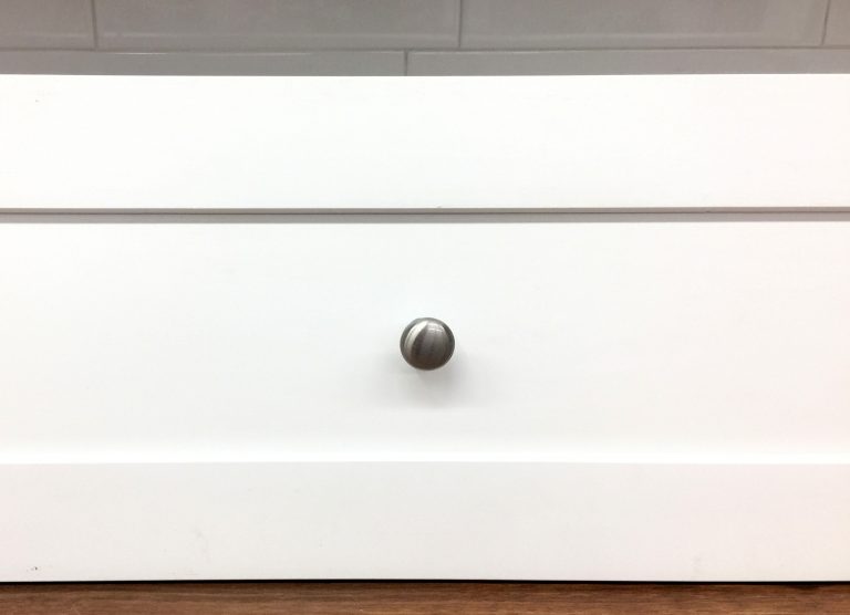 knob installed shaker style cabinet drawer front