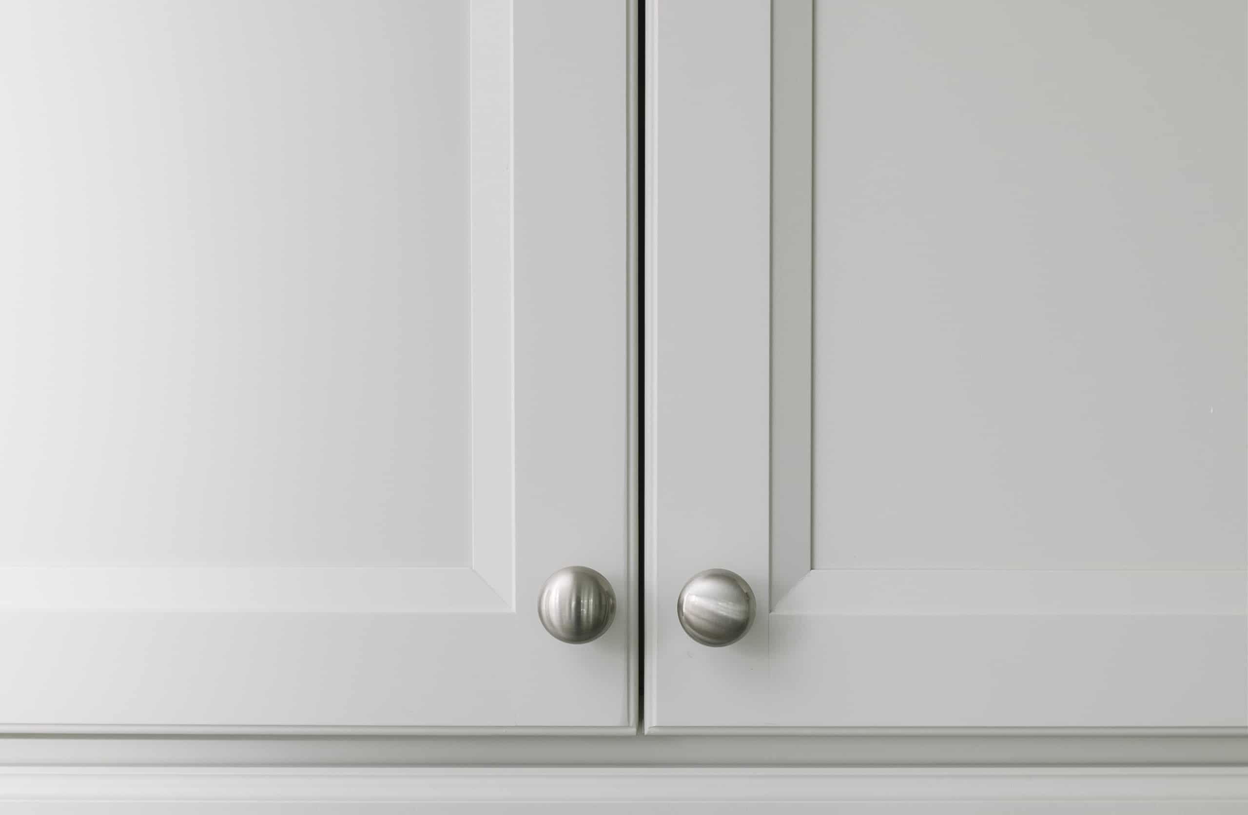 White kitchen cabinet door traditional style knobs installed