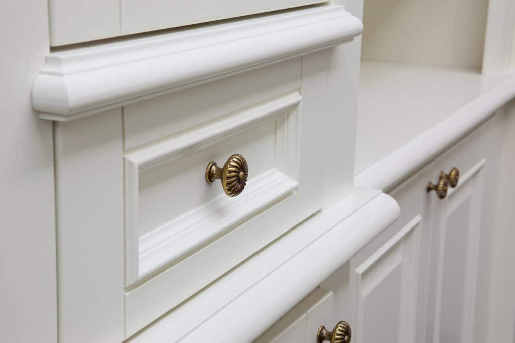 white cabinet door with metal beaded knob